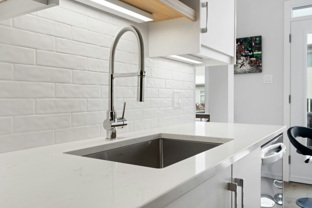 Kitchen sink and countertop installation with modern pull-down faucet
